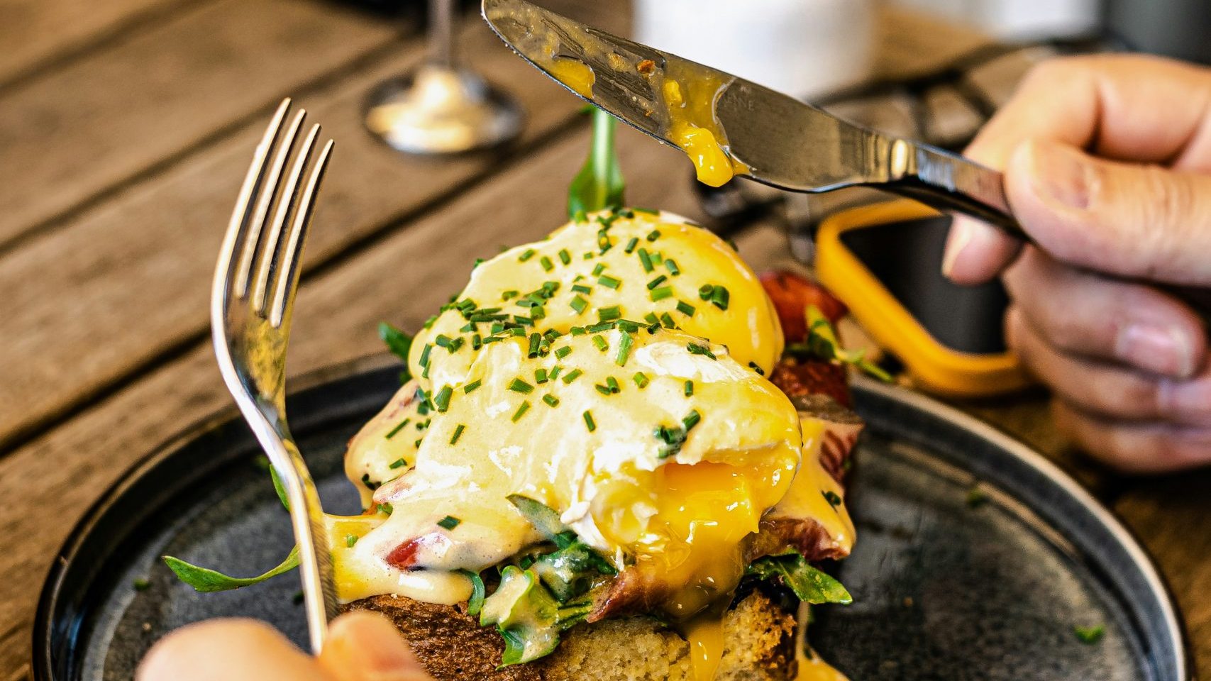Delicious brunch spread with pancakes, eggs Benedict, avocado toast, and fresh coffee at a trendy café in Amsterdam