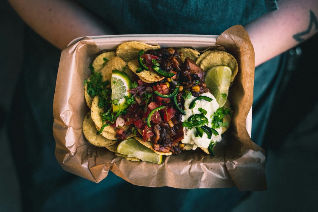 a photo of a street food with chips and meat